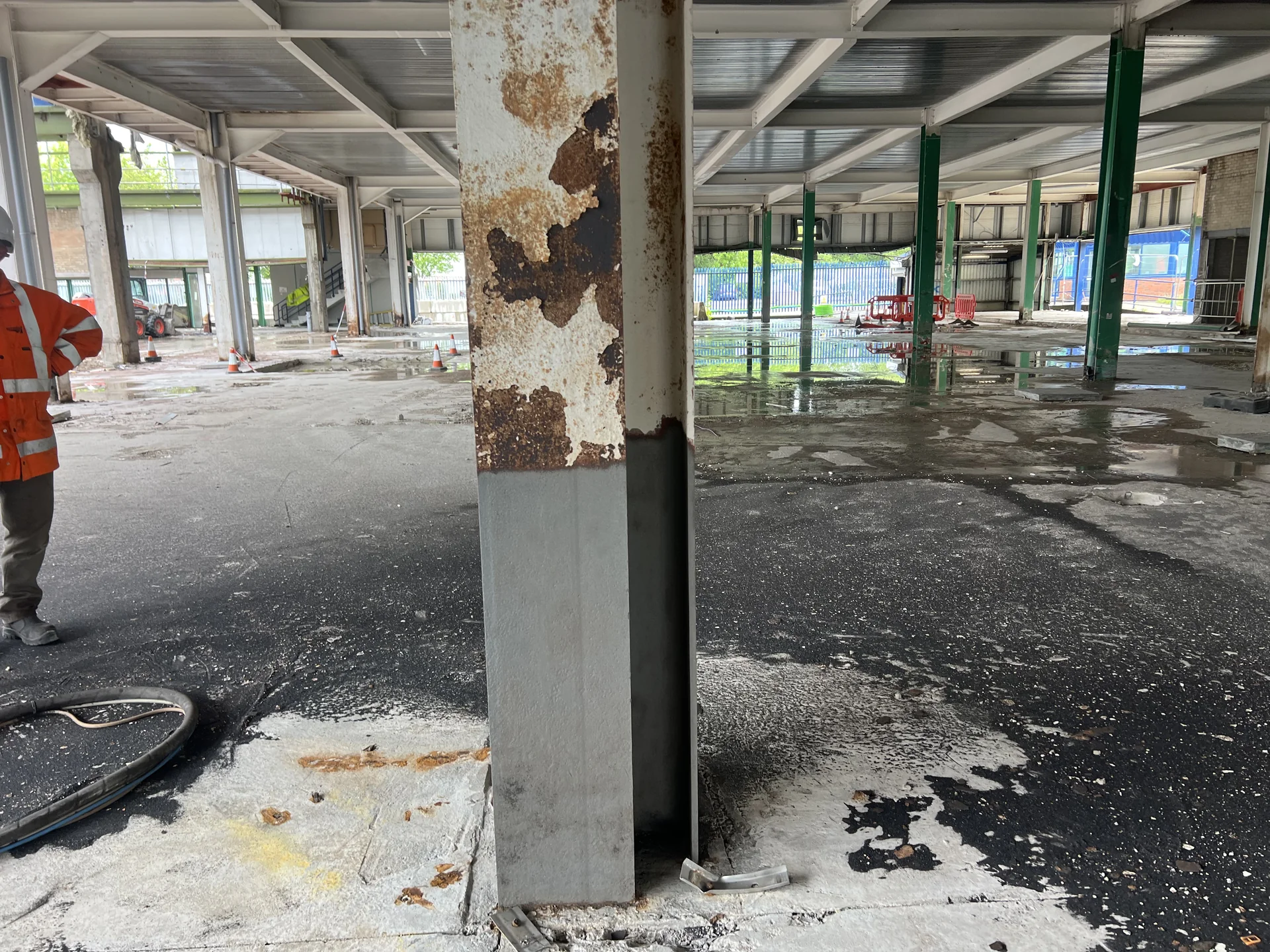 Peeling paint and corrosion visible on a steel column in the documented industrial setting