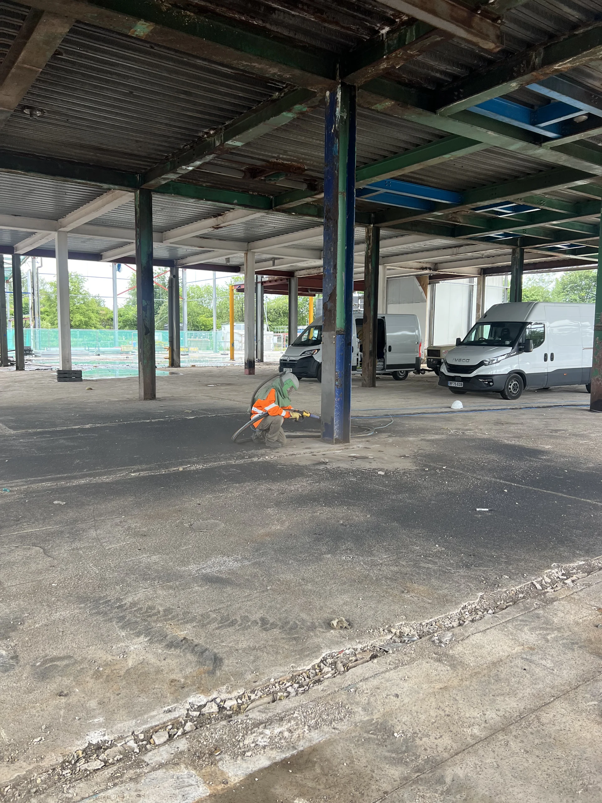 Wide view of steel columns in the partly sheltered industrial setting