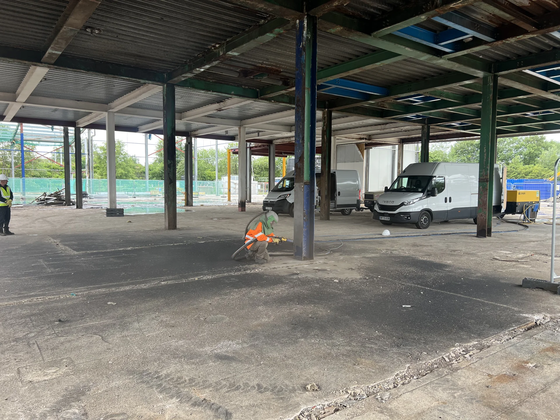 Structural steel columns and surface-preparation equipment in the work area