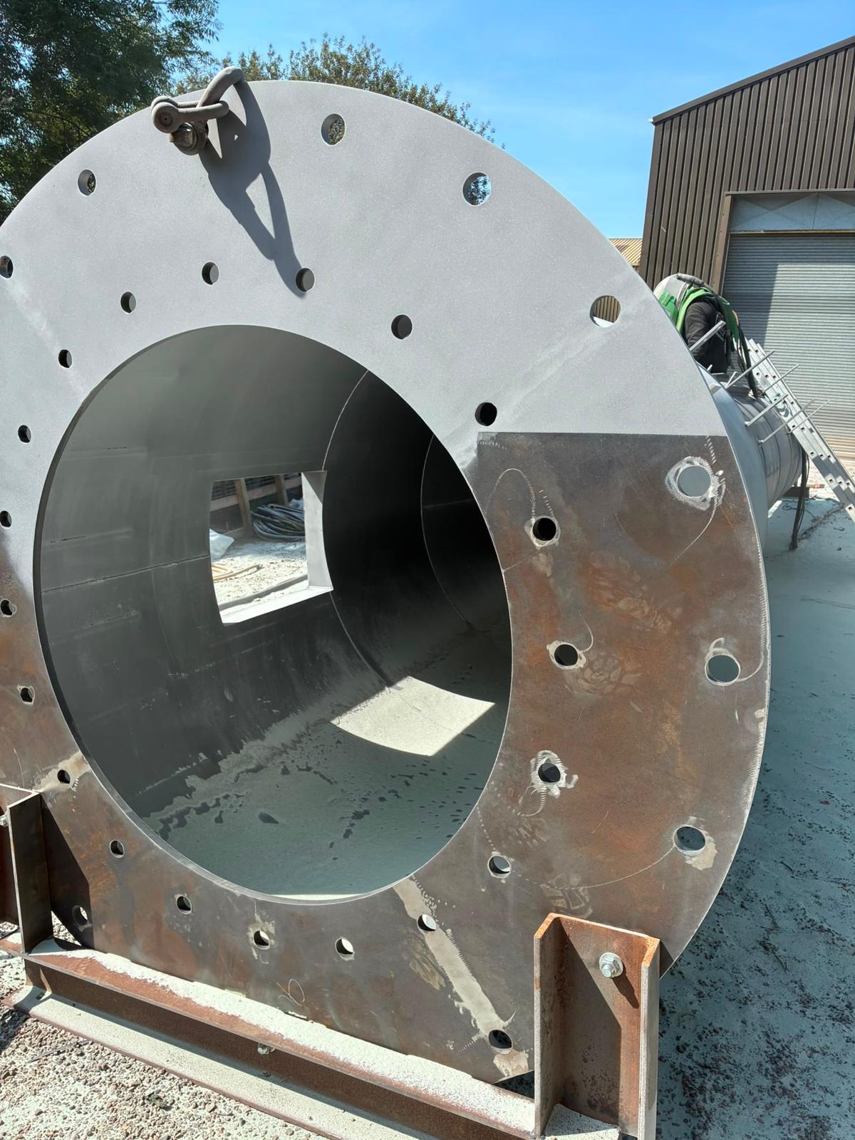 Steel chimney end section before shot blasting — flange and internal surface detail