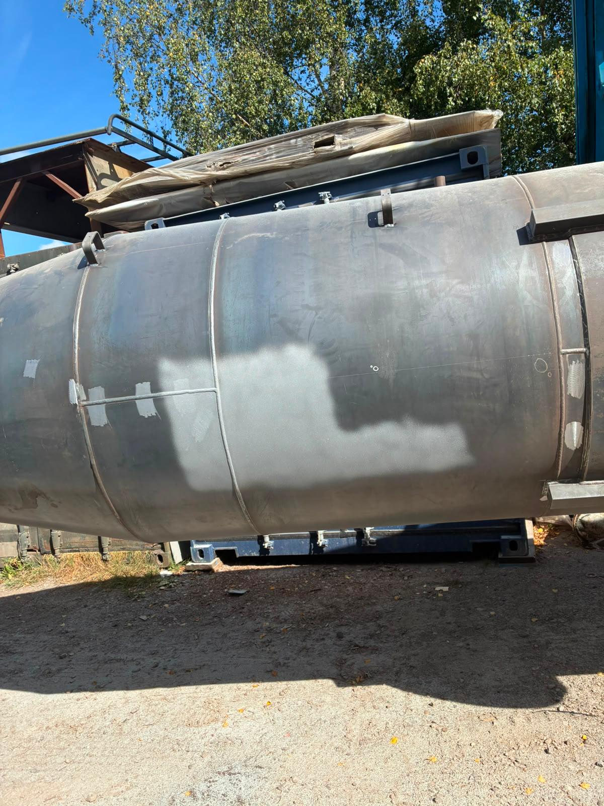 Steel chimney during preparation — curved body and bracket detail