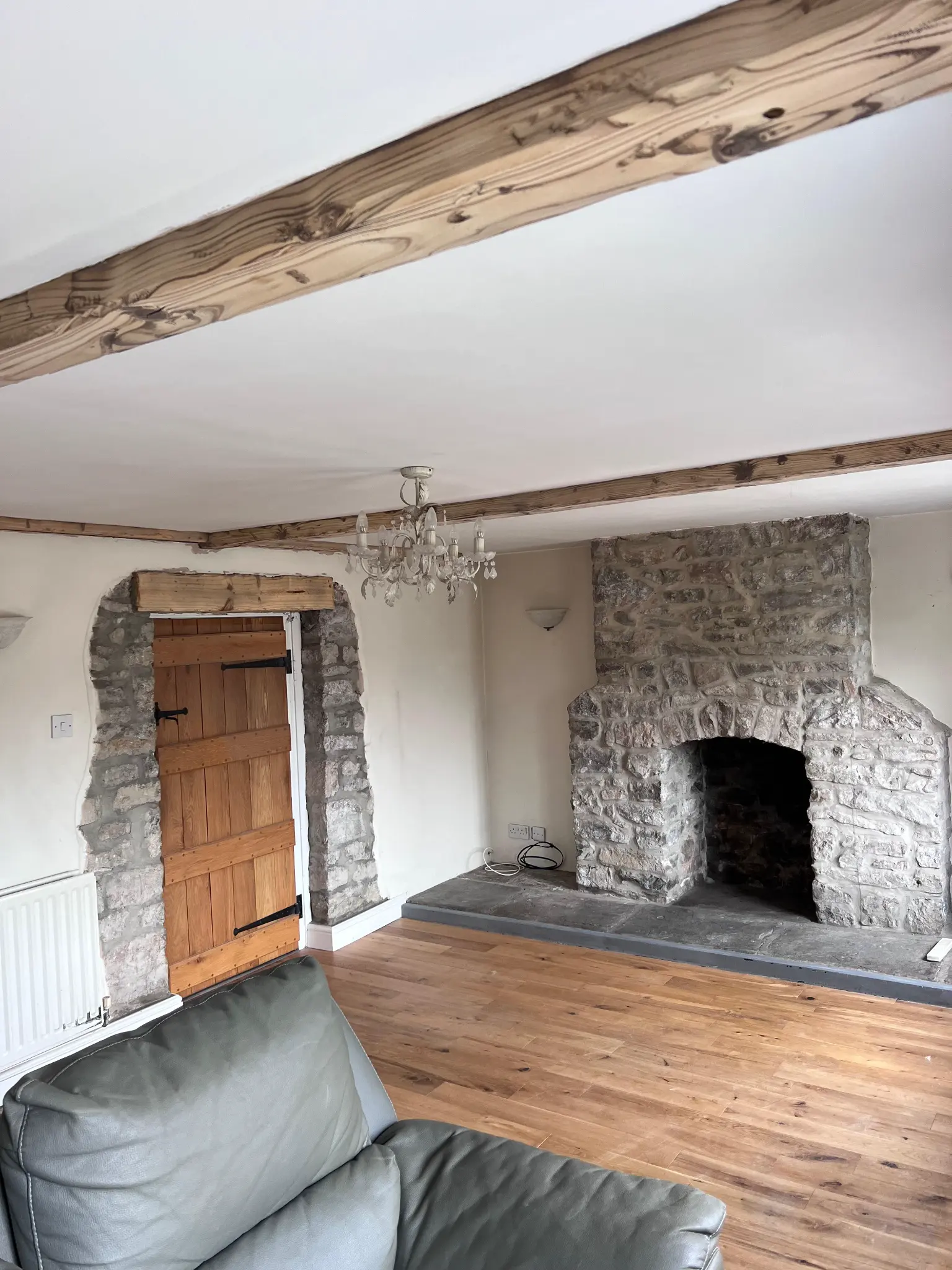 Natural timber beams above the stone fireplace after restoration