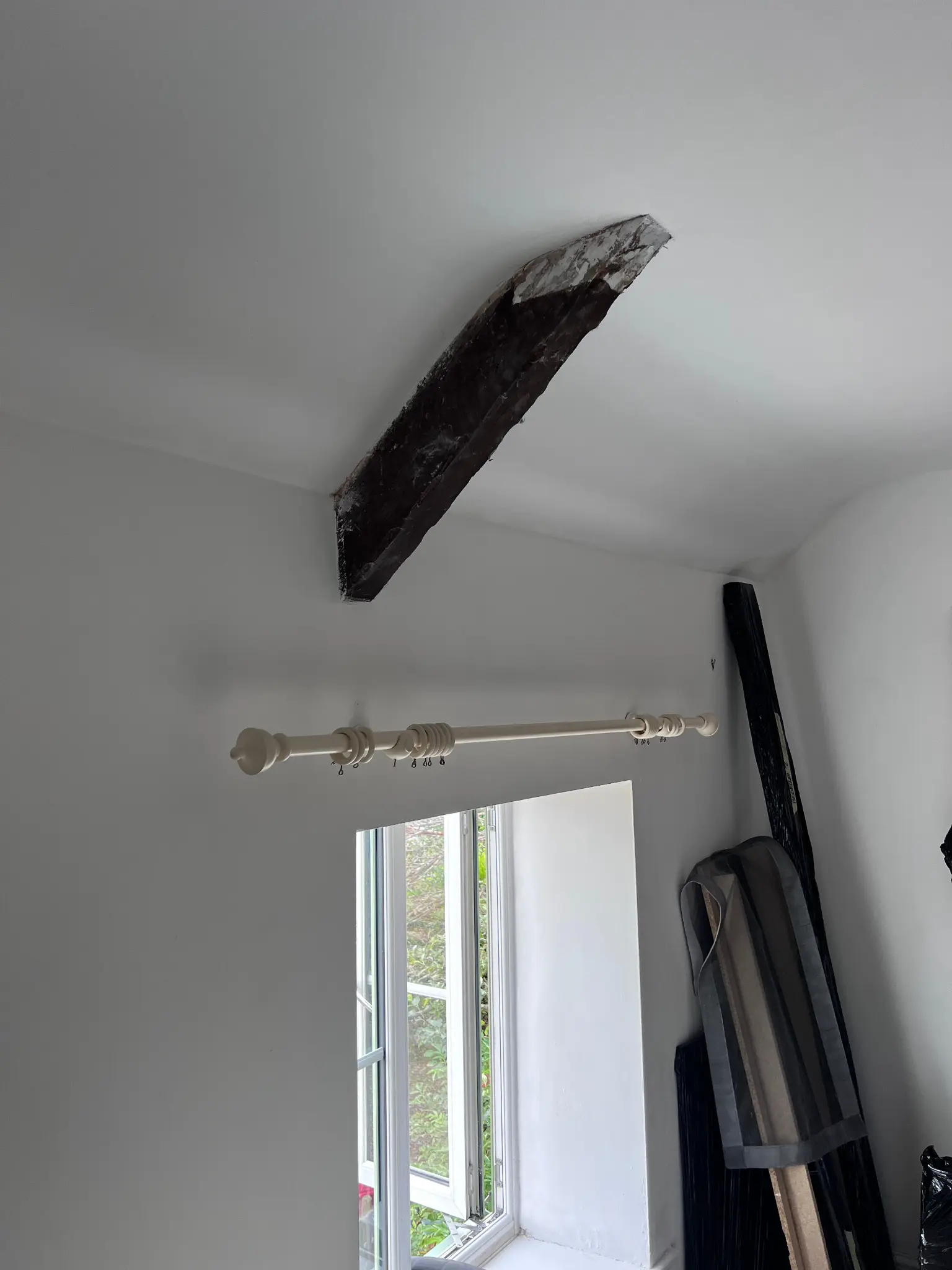 Dark-coated feature beam above the window before restoration